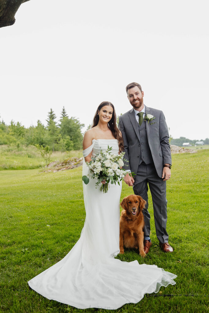 Bride and groom posing with golden retriever at Homestead 1880 in Ottawa, ON.