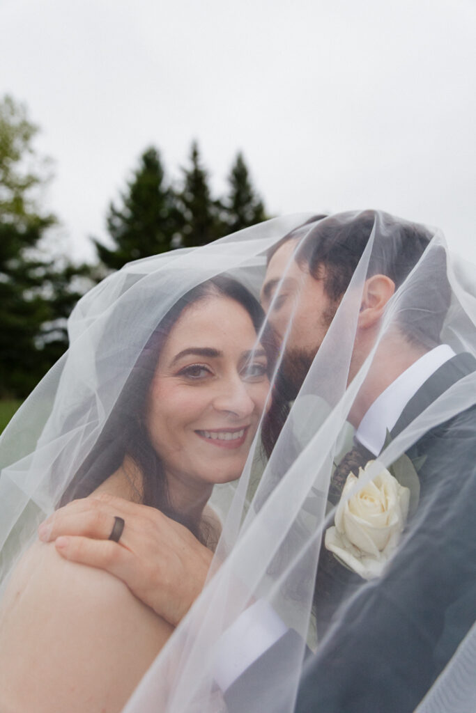 Under the veil shot of bride and groom during golden hour at The Herb Garden in Almonte, ON. 