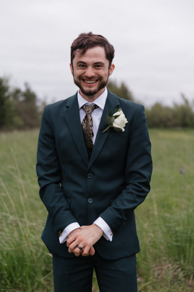 Groom portrait in a field at The Herb Garden in Almonte, ON. 